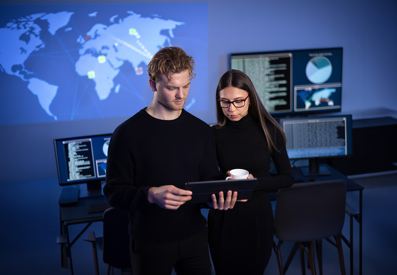 Vom Monitoring zur Fachanwendung: Prometheus-Alerts für Business-Prozesse nutzbar machen Junger Mann und junge Frau vor Monitoren schauen auf ein Laptop